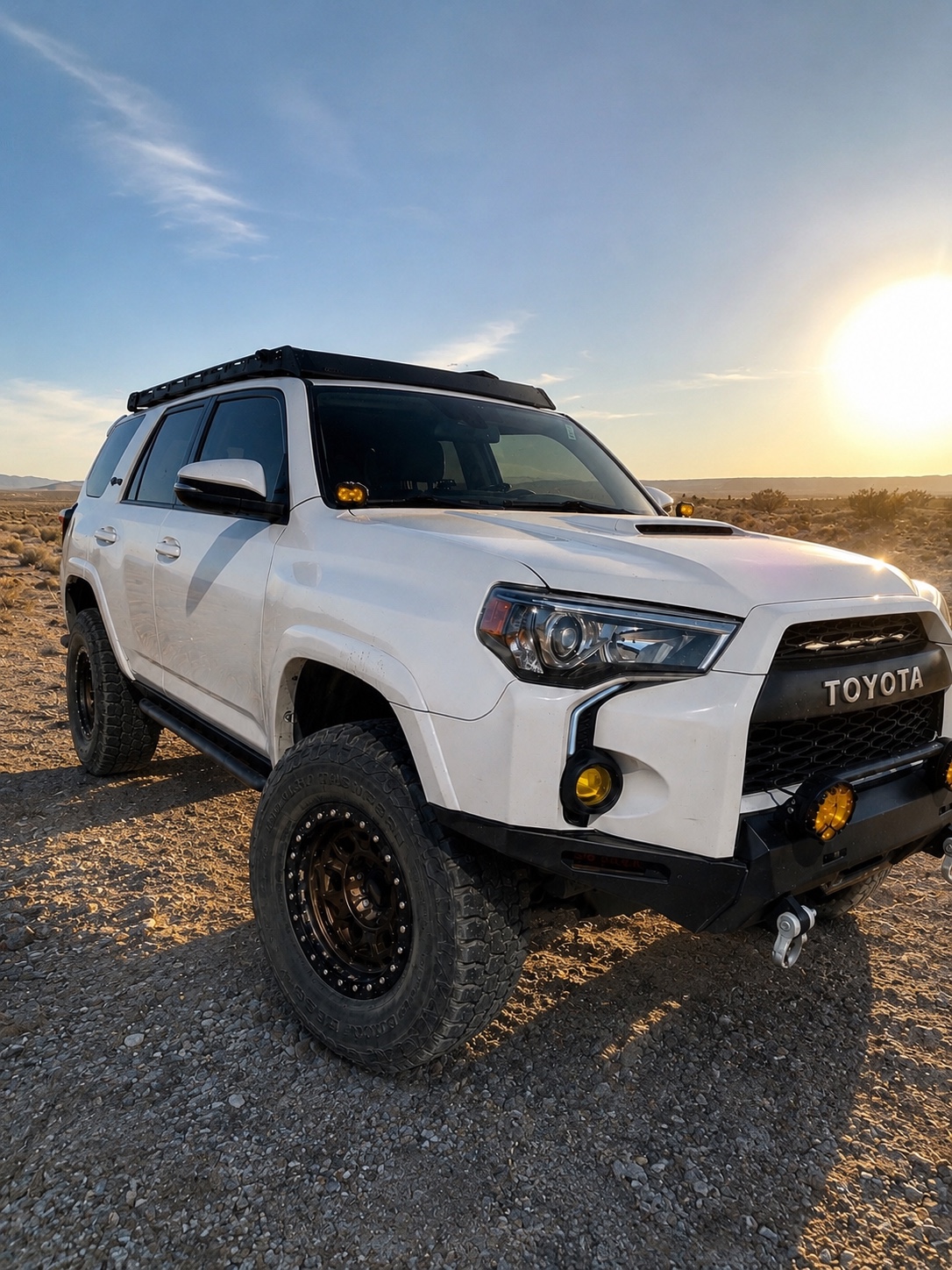 White 4Runner with roof rack, armor, and auxiliary lights